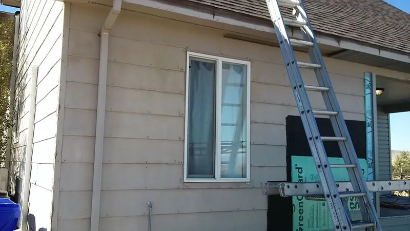 Home before new siding and bay window addition