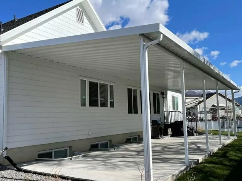 White home with white aluminum patio cover