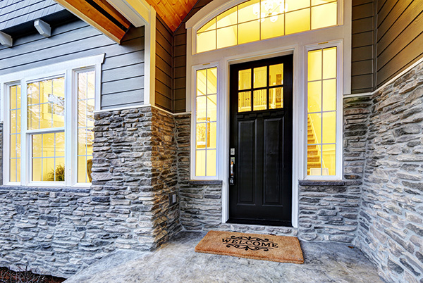 Covered porch with black front door with windows flanking each side