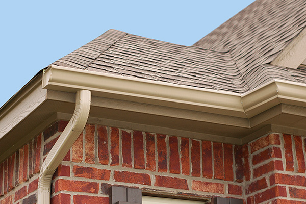 Tan gutters on a red brick house