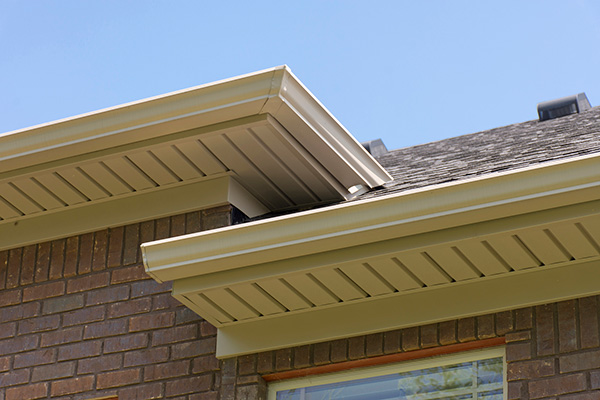 View of tan soffits on a red brick house