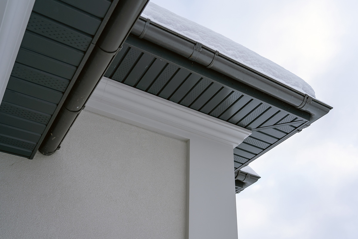 Underside view of black sofit on a white home