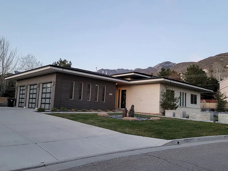 House with gravel driveway and new white siding